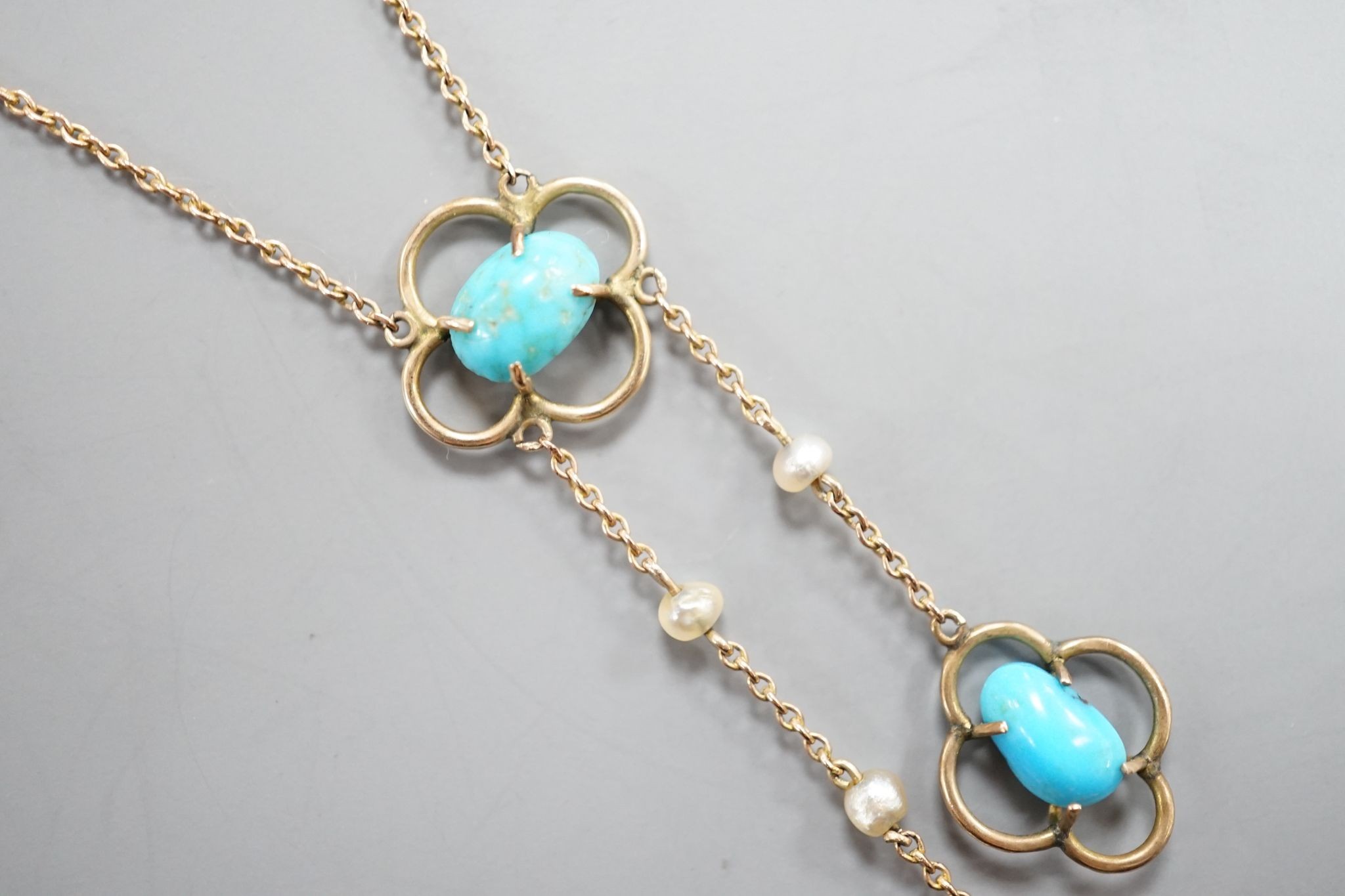 An Edwardian 9ct , three stone turquoise and three stone seed pearl set graduated double drop pendant necklace, 50cm, gross weight 3.1 grams.